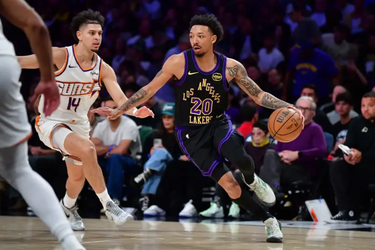 Apr 10, 2026; Los Angeles, California, USA; Los Angeles Lakers guard Nick Smith Jr. (20) moves the ball against Phoenix Suns guard Koby Brea (14) during the second half at Crypto.com Arena. Mandatory Credit: Gary A. Vasquez-Imagn Images