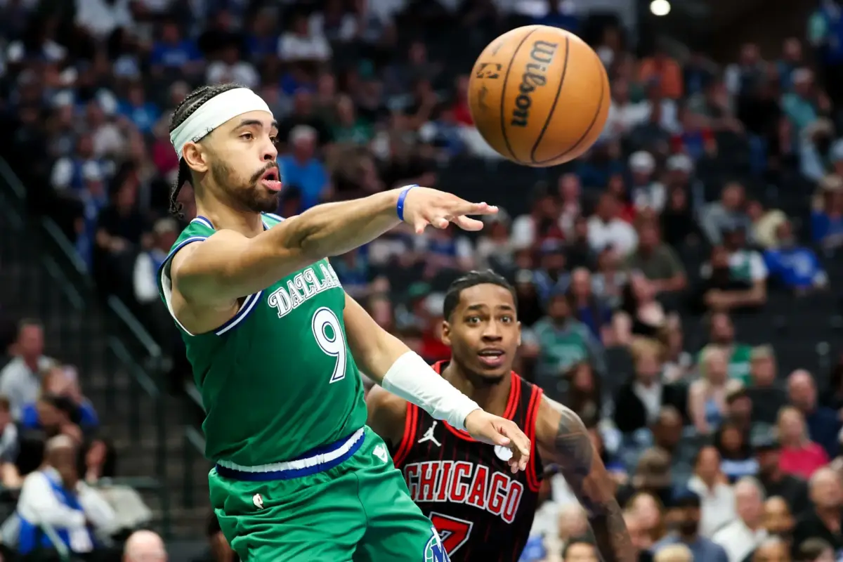 Apr 12, 2026; Dallas, Texas, USA; Dallas Mavericks guard Ryan Nembhard (9) passes the ball past Chicago Bulls guard Rob Dillingham (7) during the second half at American Airlines Center. Mandatory Credit: Kevin Jairaj-Imagn Images