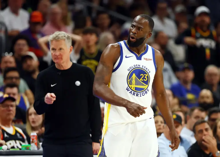 Golden State Warriors forward Draymond Green (23) reacts alongside head coach Steve Kerr against the Phoenix Suns during the second half in the play-in rounds of the 2026 NBA Playoffs at Mortgage Matchup Center.
