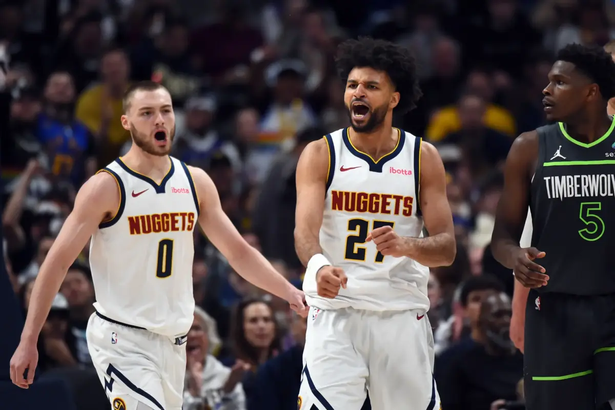 Denver Nuggets guard Jamal Murray (27) and guard Christian Braun (0) celebrate after a basket and foul during the second half against the Minnesota Timberwolves in game one of the first round of the 2026 NBA Playoffs at Ball Arena.
