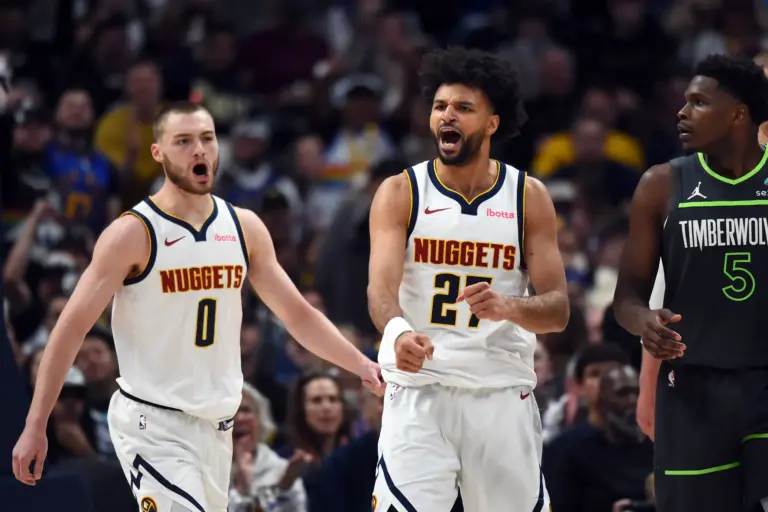 Denver Nuggets guard Jamal Murray (27) and guard Christian Braun (0) celebrate after a basket and foul during the second half against the Minnesota Timberwolves in game one of the first round of the 2026 NBA Playoffs at Ball Arena.