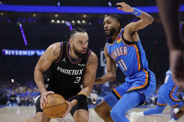 Phoenix Suns forward Dillon Brooks (3) is defended by Oklahoma City Thunder guard Isaiah Joe (11) on a drive to the basket in the second quarter during game one of the first round of the 2026 NBA Playoffs at Paycom Center.