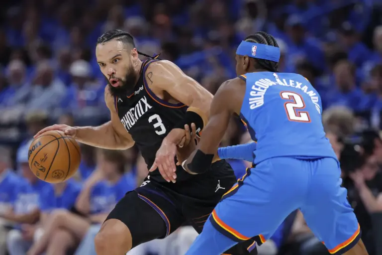 Phoenix Suns forward Dillon Brooks (3) drives around Oklahoma City Thunder guard Shai Gilgeous-Alexander (2) in the second quarter during game one of the first round of the 2026 NBA Playoffs at Paycom Center.