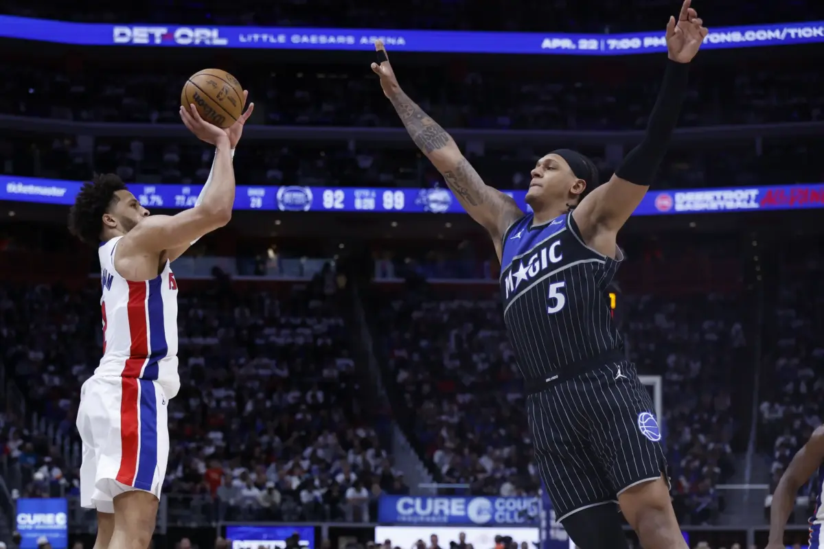 Detroit Pistons guard Cade Cunningham (2) shoots on Orlando Magic forward Paolo Banchero (5) in the second half during the 2026 NBA Playoffs at Little Caesars Arena.