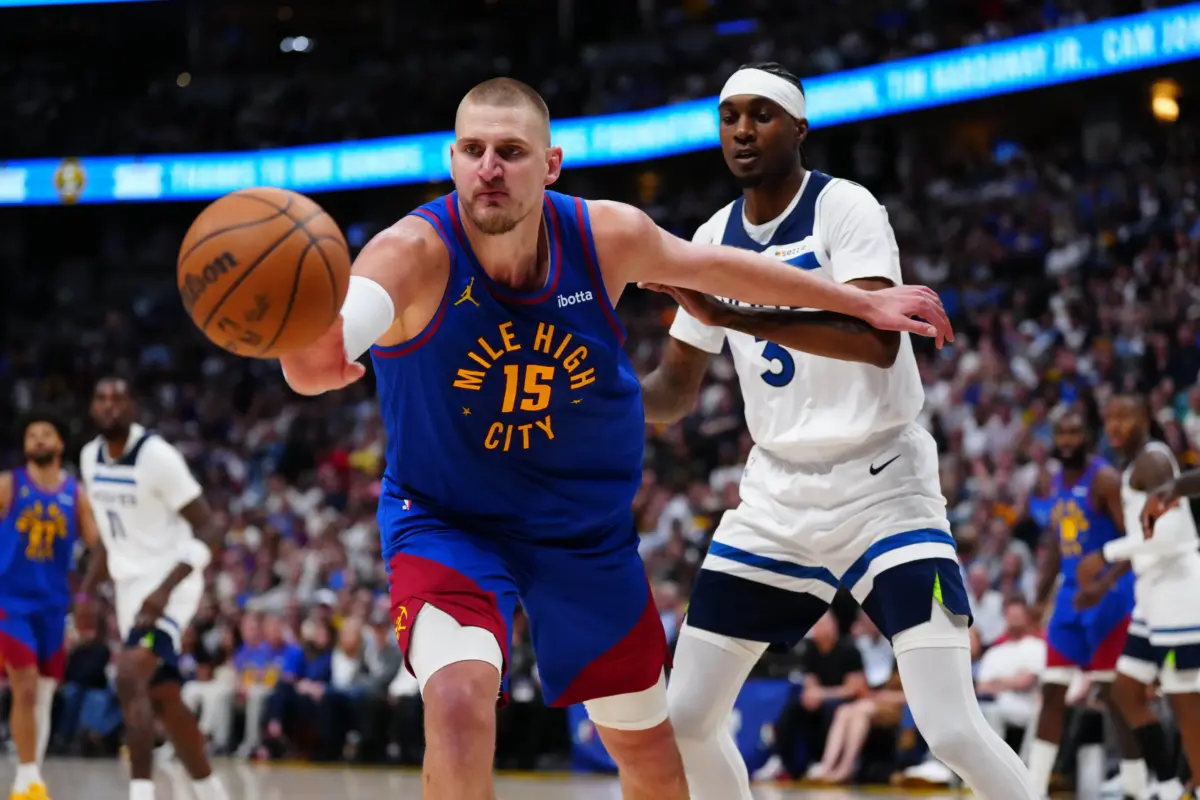 Apr 20, 2026; Denver, Colorado, USA; Minnesota Timberwolves forward Jaden McDaniels (3) defends on Denver Nuggets center Nikola Jokic (15) in the second half during game two of the first round of the 2026 NBA Playoffs at Ball Arena. Mandatory Credit: Ron Chenoy-Imagn Images