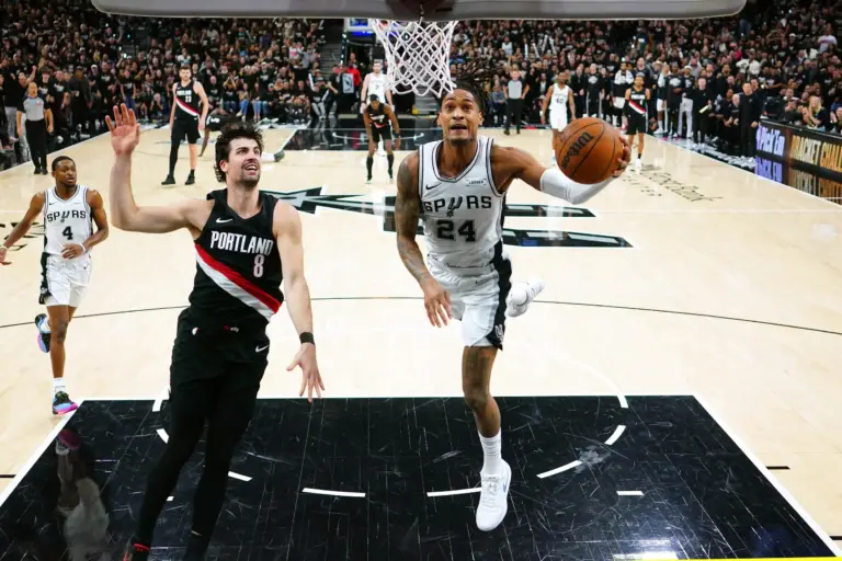 Apr 21, 2026; San Antonio, Texas, USA; San Antonio Spurs guard Devin Vassell (24) drives against Portland Trail Blazers forward Deni Avdija (8) during the second half of game two of the first round of the 2026 NBA Playoffs at Frost Bank Center. Mandatory Credit: Scott Wachter-Imagn Images