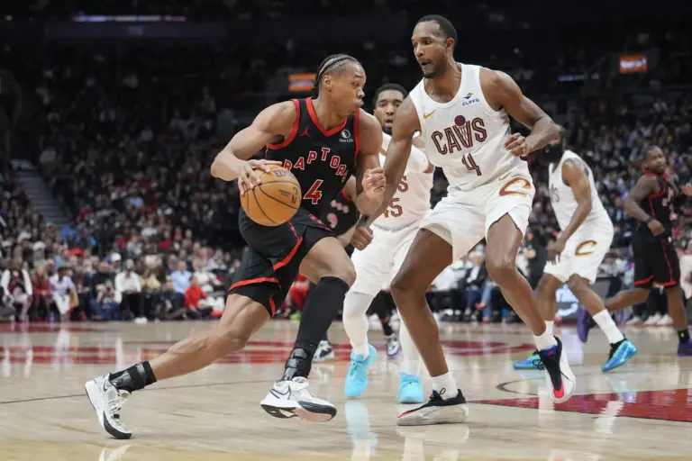 Toronto Raptors guard Scottie Barnes (4) drives to the basket against Cleveland Cavaliers forward Evan Mobley (4) during the first half of game three of the first round of the 2026 NBA Playoffs at Scotiabank Arena.