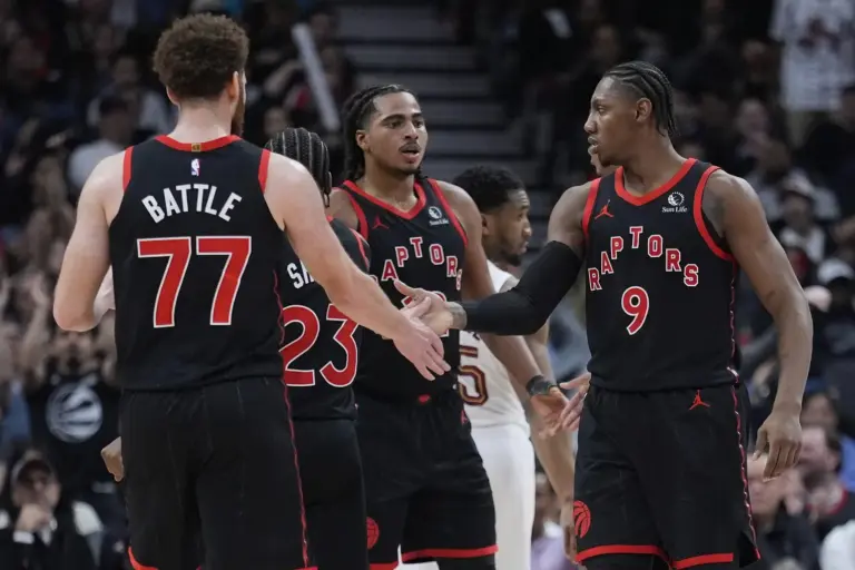 Apr 23, 2026; Toronto, Ontario, CAN; Toronto Raptors forward Jamison Battle (77) and forward Collin Murray-Boyles (12) congratulate forward RJ Barrett (9) after a play against the Cleveland Cavaliers during the second half of game three of the first round of the 2026 NBA Playoffs at Scotiabank Arena. Mandatory Credit: John E. Sokolowski-Imagn Images