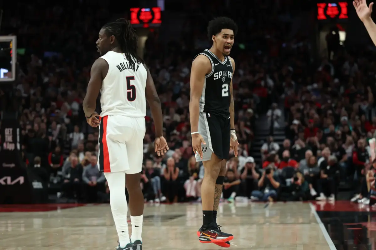 Apr 24, 2026; Portland, Oregon, USA; San Antonio Spurs guard Dylan Harper (2) reacts after scoring against Portland Trail Blazers guard Jrue Holiday (5) during the second half during game three of the first round of the 2026 NBA Playoffs at Moda Center. Mandatory Credit: Jaime Valdez-Imagn Images