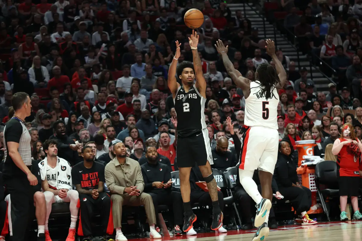 Apr 24, 2026; Portland, Oregon, USA; San Antonio Spurs guard Dylan Harper (2) shoots the ball over Portland Trail Blazers guard Jrue Holiday (5) during the second half during game three of the first round of the 2026 NBA Playoffs at Moda Center. Mandatory Credit: Jaime Valdez-Imagn Images