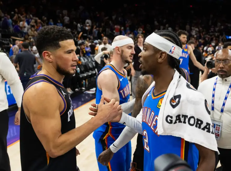 Oklahoma City Thunder guard Shai Gilgeous-Alexander (2) greets Phoenix Suns guard Devin Booker (1) after advancing in a four game sweep of the first round of the 2026 NBA Playoffs at Mortgage Matchup Center.