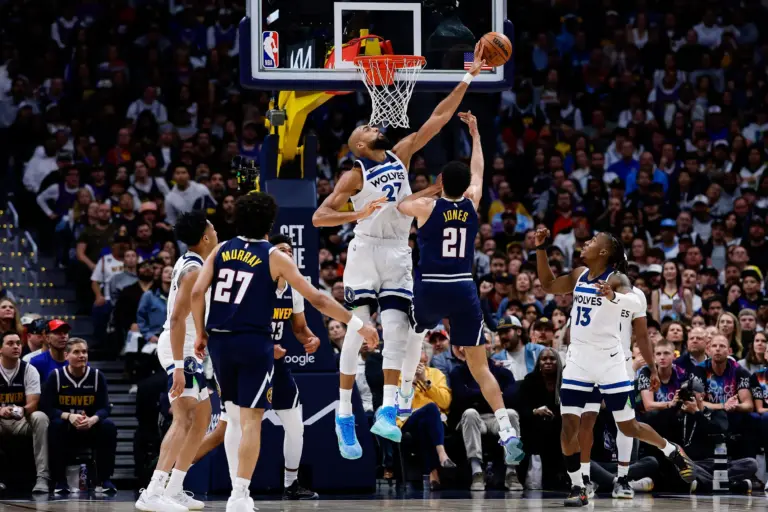 Apr 27, 2026; Denver, Colorado, USA; Minnesota Timberwolves center Rudy Gobert (27) blocks the shot of Denver Nuggets forward Spencer Jones (21) as guard Ayo Dosunmu (13) and forward Cameron Johnson (23) and guard Jamal Murray (27) and guard Terrence Shannon Jr. (1) defend in the first quarter during game five of the first round of the 2026 NBA Playoffs at Ball Arena. Mandatory Credit: Isaiah J. Downing-Imagn Images