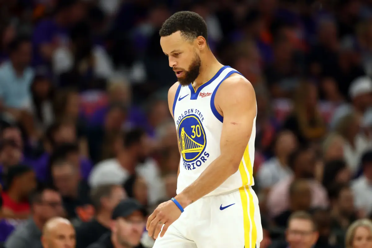 Golden State Warriors star Stephen Curry walks on court during game against Phoenix Suns
