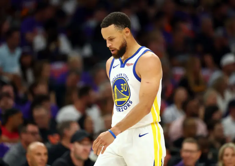 Golden State Warriors star Stephen Curry walks on court during game against Phoenix Suns