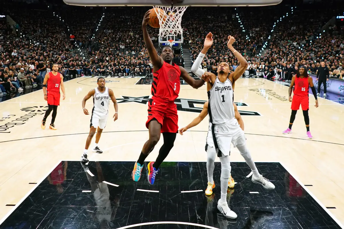 Portland Trail Blazers guard Jrue Holiday attempts a layup against San Antonio Spurs big man Victor Wembanyama