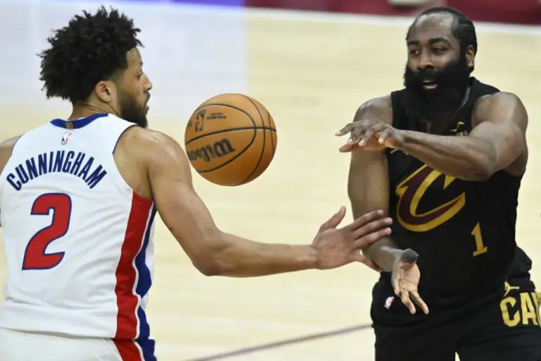 Cleveland Cavaliers guard James Harden (1) throws a pass beside Detroit Pistons guard Cade Cunningham (2) in the fourth quarter at Rocket Arena in a Cavaliers vs Pistons matchup.