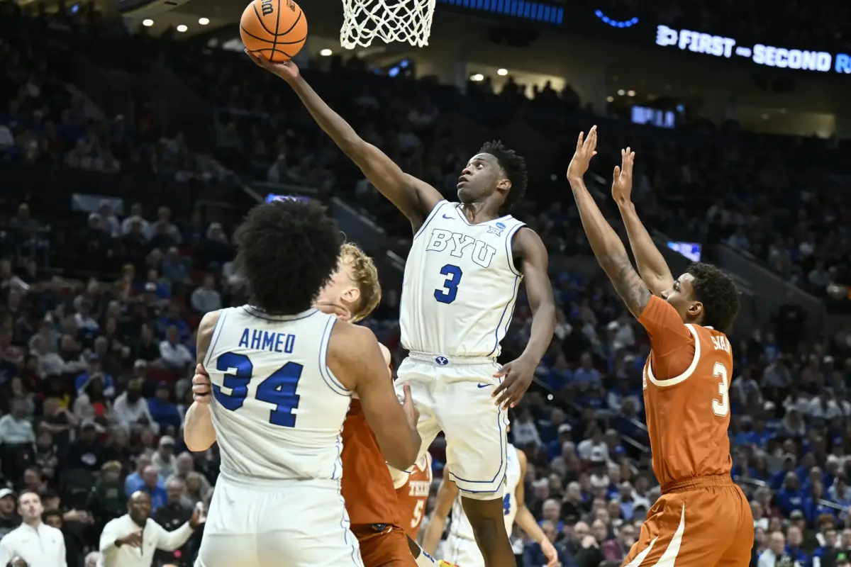 BYU Cougars forward AJ Dybantsa (3) shoots against Texas Longhorns forward Dailyn Swain (3) in the first half during a first round game of the men's 2026 NCAA Tournament at Moda Center. The Washington Wizards may potential trade the first pick to the Utah Jazz, in which Utah will select Dybantsa.