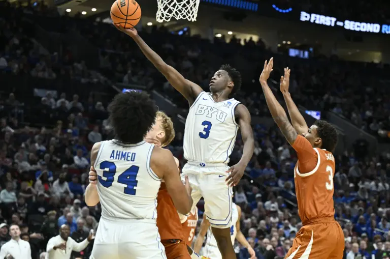 BYU Cougars forward AJ Dybantsa (3) shoots against Texas Longhorns forward Dailyn Swain (3) in the first half during a first round game of the men's 2026 NCAA Tournament at Moda Center. The Washington Wizards may potential trade the first pick to the Utah Jazz, in which Utah will select Dybantsa.