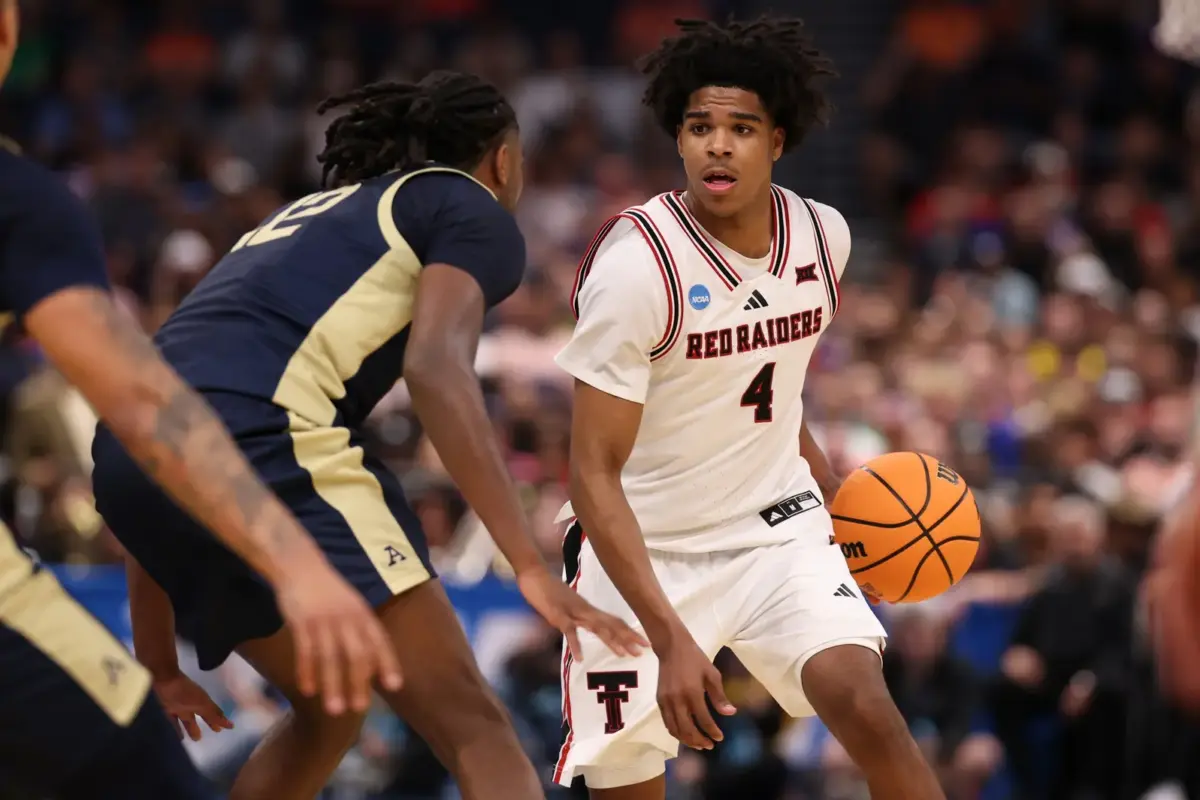 Texas Tech Red Raiders guard Christian Anderson (4) dribbles against Akron Zips guard Evan Mahaffey (12) in the first half during a first round game of the men's 2026 NCAA Tournament at Benchmark International Arena.