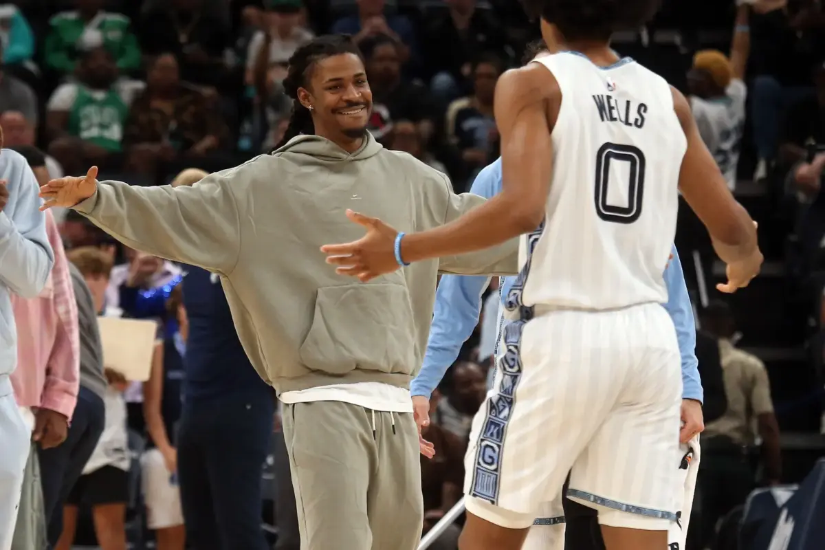Memphis Grizzlies guard Ja Morant (left) reacts with forward Jaylen Wells (0) during a timeout during the fourth quarter against the Boston Celtics at FedExForum.