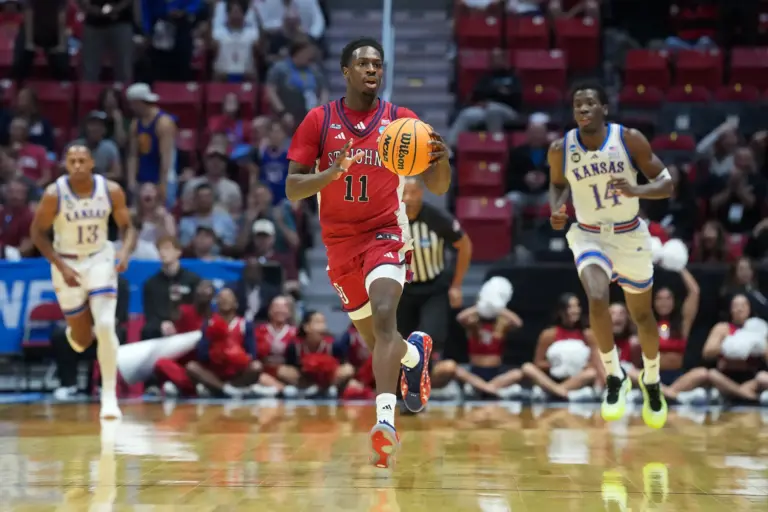 St. John's Red Storm guard Ian Jackson (11) controls the ball against the Kansas Jayhawks in the first half during a second round game of the men's 2026 NCAA Tournament at Viejas Arena.