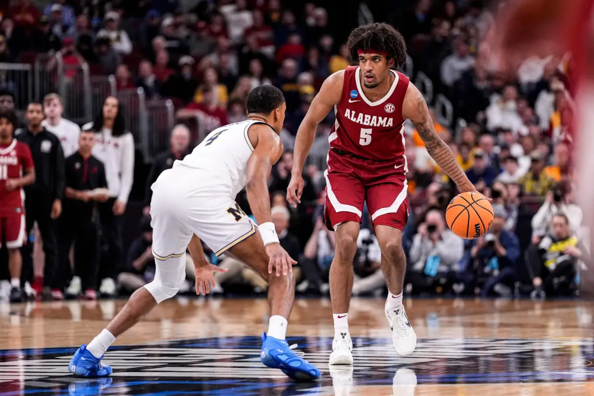 Alabama forward Amari Allen (5) dribbles against Michigan guard Nimari Burnett (4) during the first half of NCAA Tournament Sweet 16 round at United Center in Chicago on Friday, March 27, 2026.
