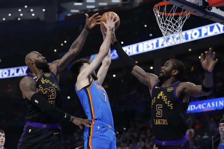 Oklahoma City Thunder center Chet Holmgren (7) goes up for a basket between Los Angeles Lakers forward LeBron James (23) and center Deandre Ayton (5) during the second half at Paycom Center in a Lakers vs Thunder matchup.