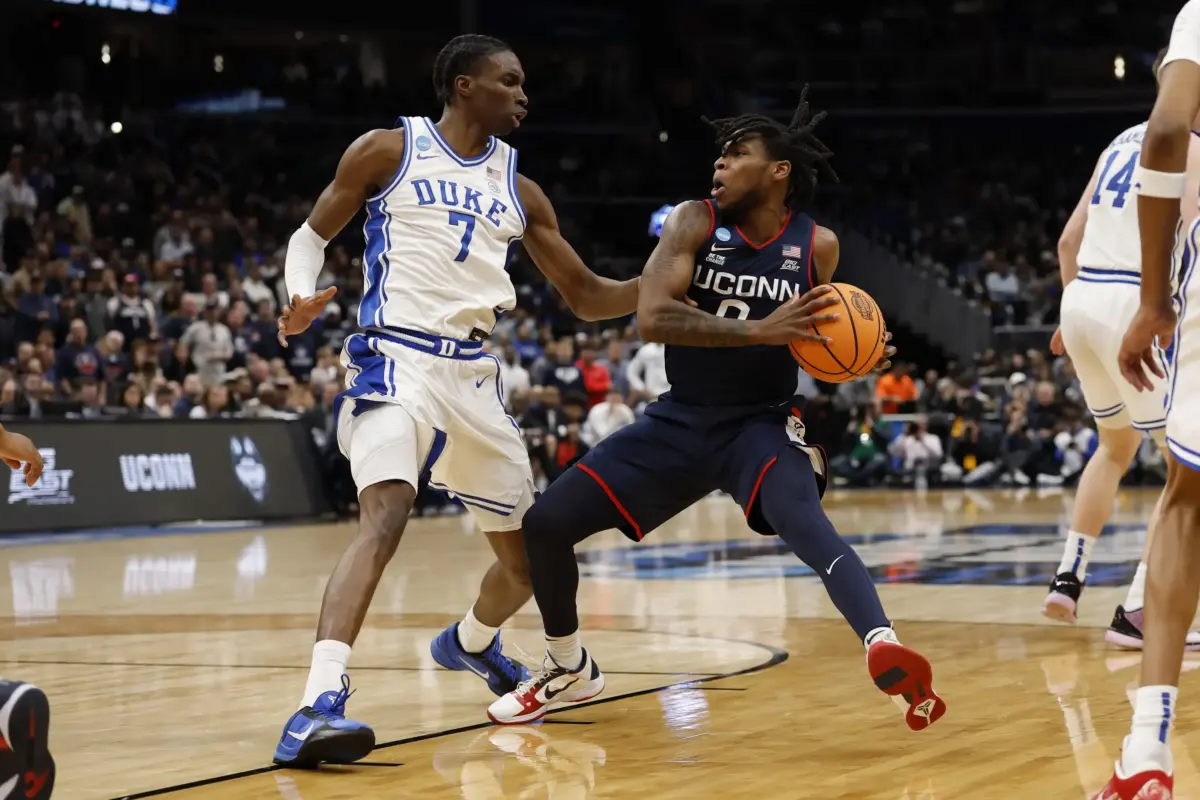 UConn Huskies guard Malachi Smith (0) drives to the basket as Duke Blue Devils guard Dame Sarr (7) defends during an Elite Eight game of the East Regional of the men's 2026 NCAA Tournament at Capital One Arena.
