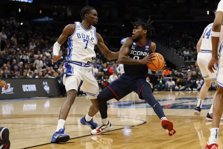 UConn Huskies guard Malachi Smith (0) drives to the basket as Duke Blue Devils guard Dame Sarr (7) defends during an Elite Eight game of the East Regional of the men's 2026 NCAA Tournament at Capital One Arena.