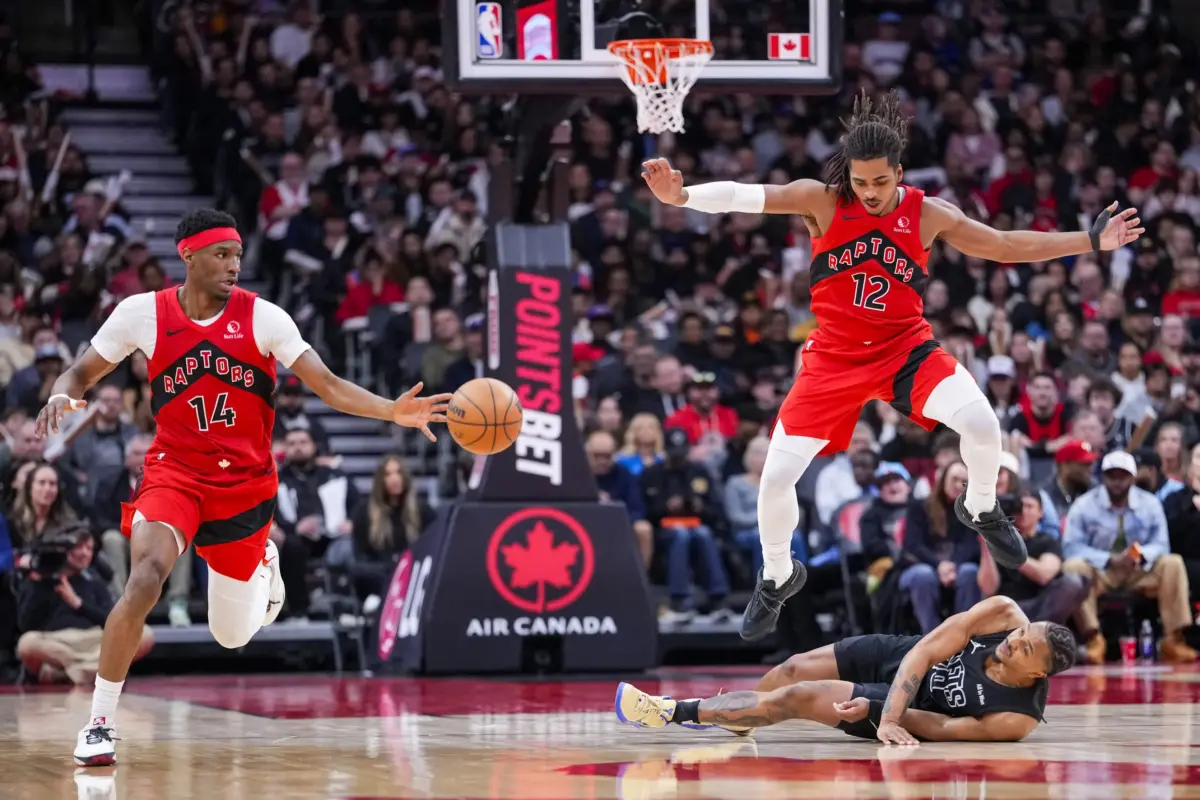 Toronto Raptors Ja'kobe Walter (14) and Collin Murray-Boyles (12) battle for a loose ball against Brooklyn Nets Tyson Etienne (10) during the second half at Scotiabank Arena. Collin Murray-Boyles in particular is the one of the best players in the Raptors young core.