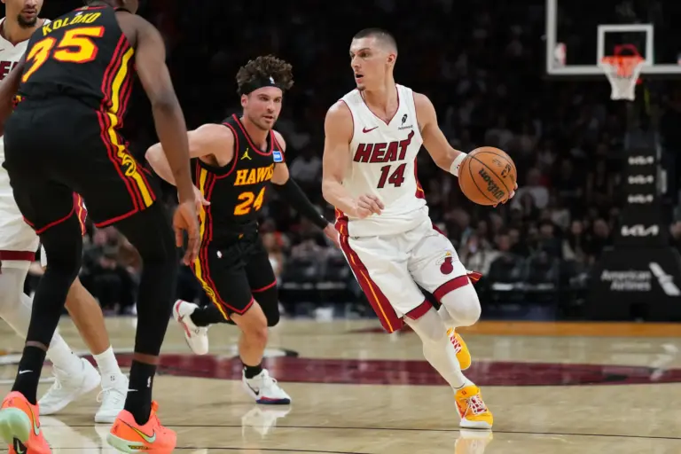 Miami Heat guard Tyler Herro (14) drives against Atlanta Hawks forward Corey Kispert (24) during the second half at Kaseya Center.