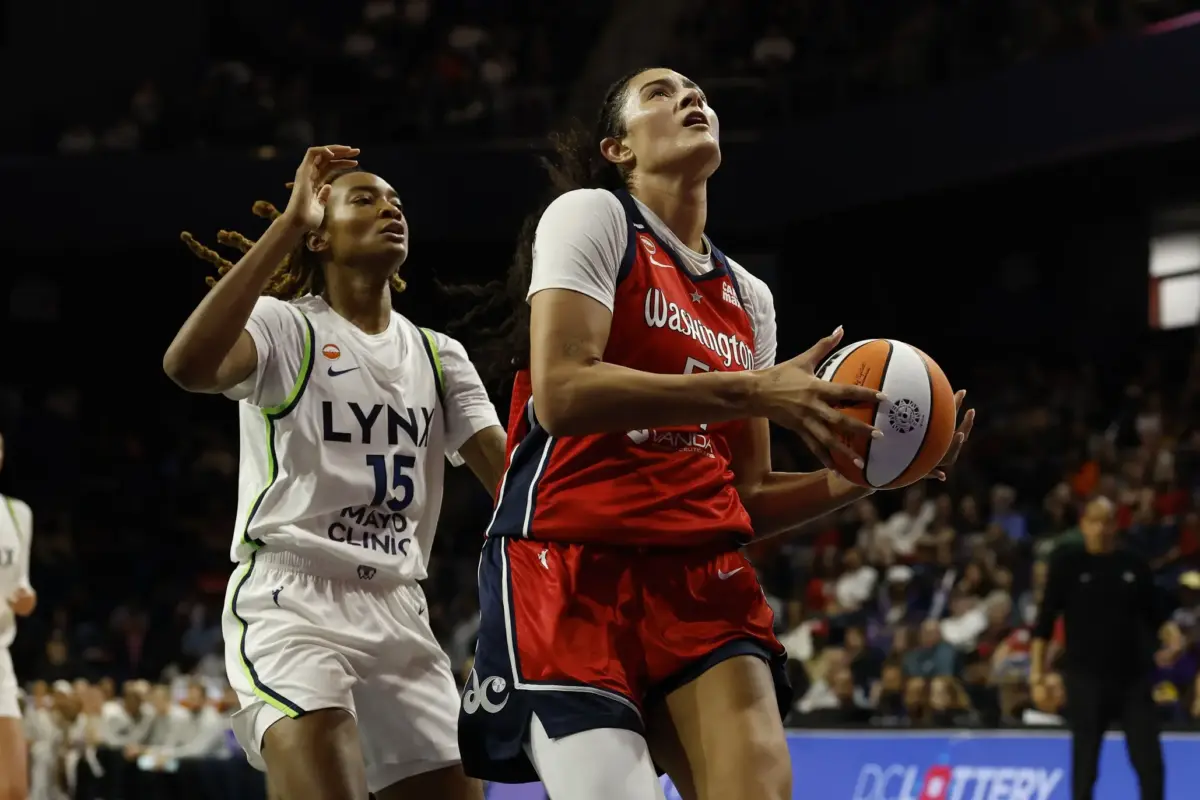 Washington Mystics center Lauren Betts (51) drives to the basket as Minnesota Lynx forward Jade Masogayo (15) defends in the first half at Entertainment & Sports Arena.