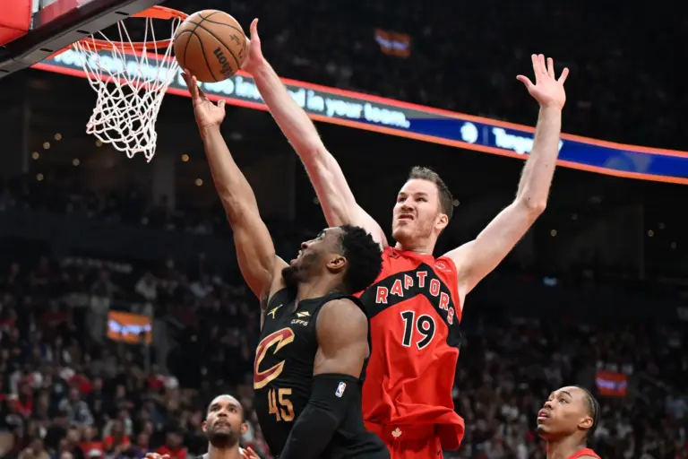Toronto Raptors center Jakob Poeltl (19) reaches to block a shot from Cleveland Cavaliers guard Donovan Mitchell (45) during game four of the first round of the 2026 NBA Playoffs at Scotiabank Arena. Jakob Poeltl trade rumors will be abound for the offseason due to his poor play.