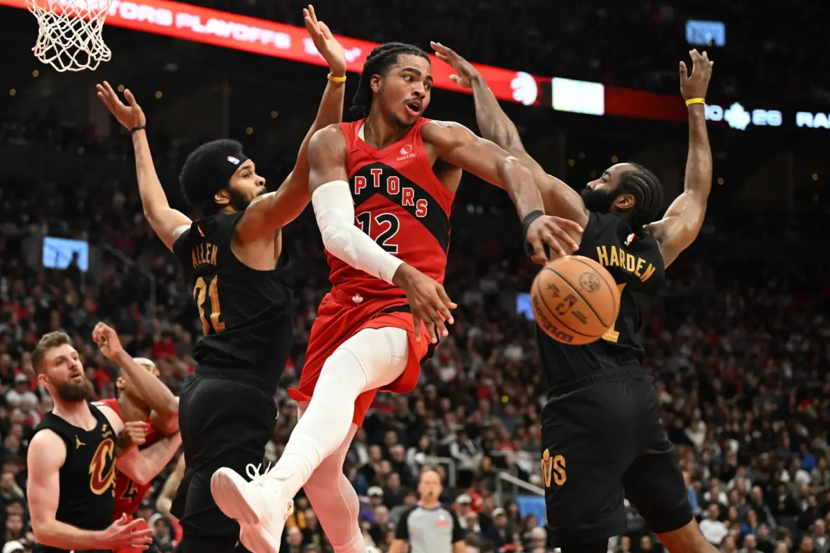 Toronto Raptors forward Collin Murray-Boyles (12) passes the ball away from Cleveland Cavaliers center Jarrett Allen (31) and guard James Harden (1) during game four of the first round of the 2026 NBA Playoffs at Scotiabank Arena.