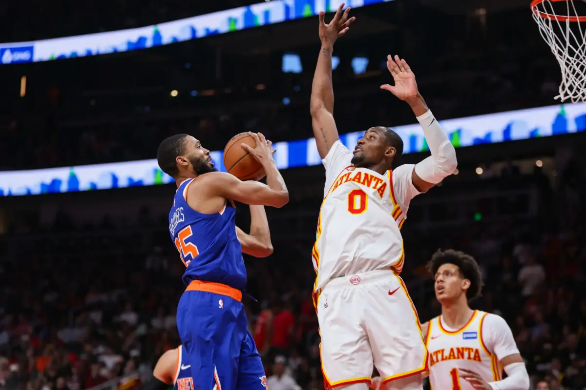 New York Knicks guard Mikal Bridges (25) shoots past Atlanta Hawks forward Jonathan Kuminga (0) in the second quarter during game six of the first round of the 2026 NBA Playoffs at State Farm Arena.