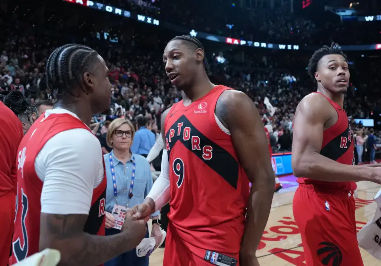 Toronto Raptors forward RJ Barrett (9) shakes hands with guard Jamal Shead (23) after scoring the winning basket against the Cleveland Cavaliers during the overtime period in game six of the first round of the 2026 NBA Playoffs at Scotiabank Arena.