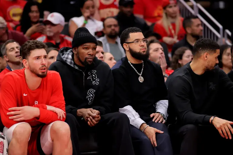Houston Rockets teammates Alperen Sengun, Kevin Durant and Fred VanVleet sit together on the bench