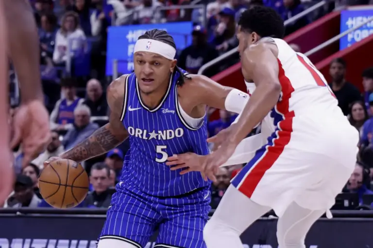 Orlando Magic forward Paolo Banchero (5) dribbles defended by Detroit Pistons forward Tobias Harris (12) in the first half during game seven of the first round of the 2026 NBA Playoffs at Little Caesars Arena.