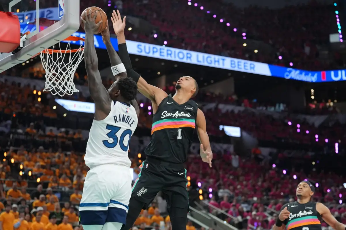 Minnesota Timberwolves forward Julius Randle (30) shoots against San Antonio Spurs forward Victor Wembanyama (1) in the first half during game one of the second round of the 2026 NBA Playoffs at Frost Bank Center.