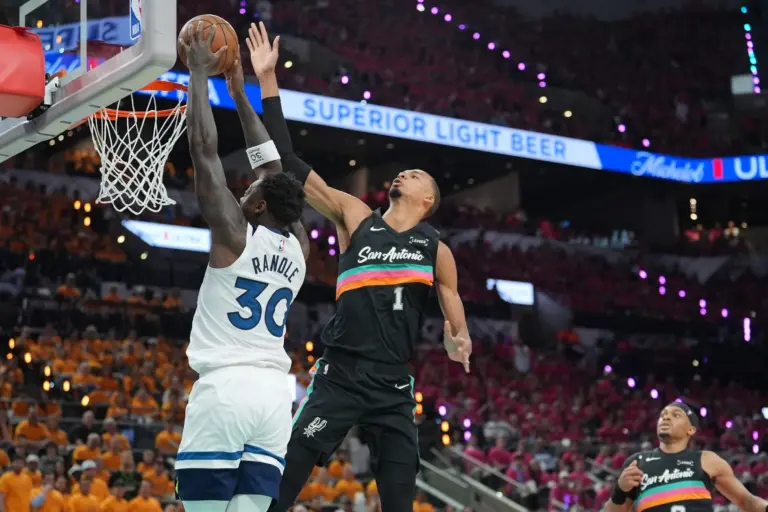 Minnesota Timberwolves forward Julius Randle (30) shoots against San Antonio Spurs forward Victor Wembanyama (1) in the first half during game one of the second round of the 2026 NBA Playoffs at Frost Bank Center.