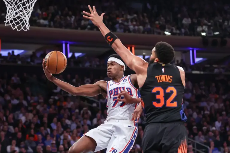 Philadelphia 76ers guard Vj Edgecombe (77) drives past New York Knicks center Karl-Anthony Towns (32) during game five of the second round of the 2026 NBA Playoffs at Madison Square Garden. Mandatory Credit: Wendell Cruz-Imagn Images