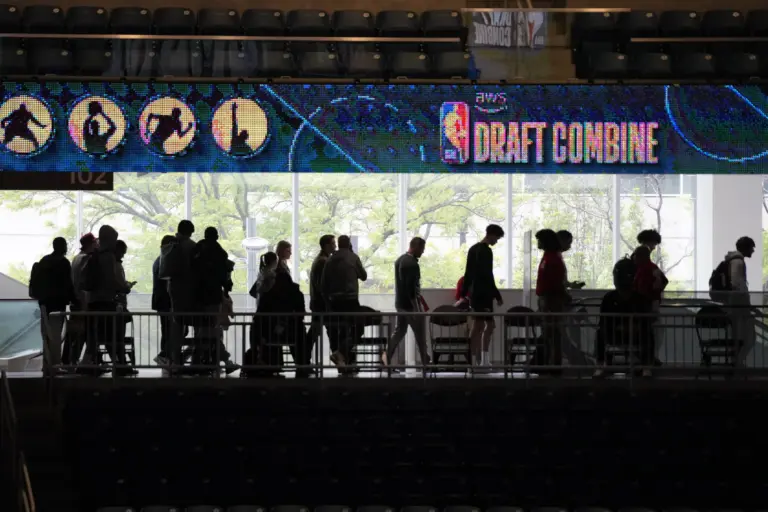 People walking under 2026 NBA Draft Combine sign