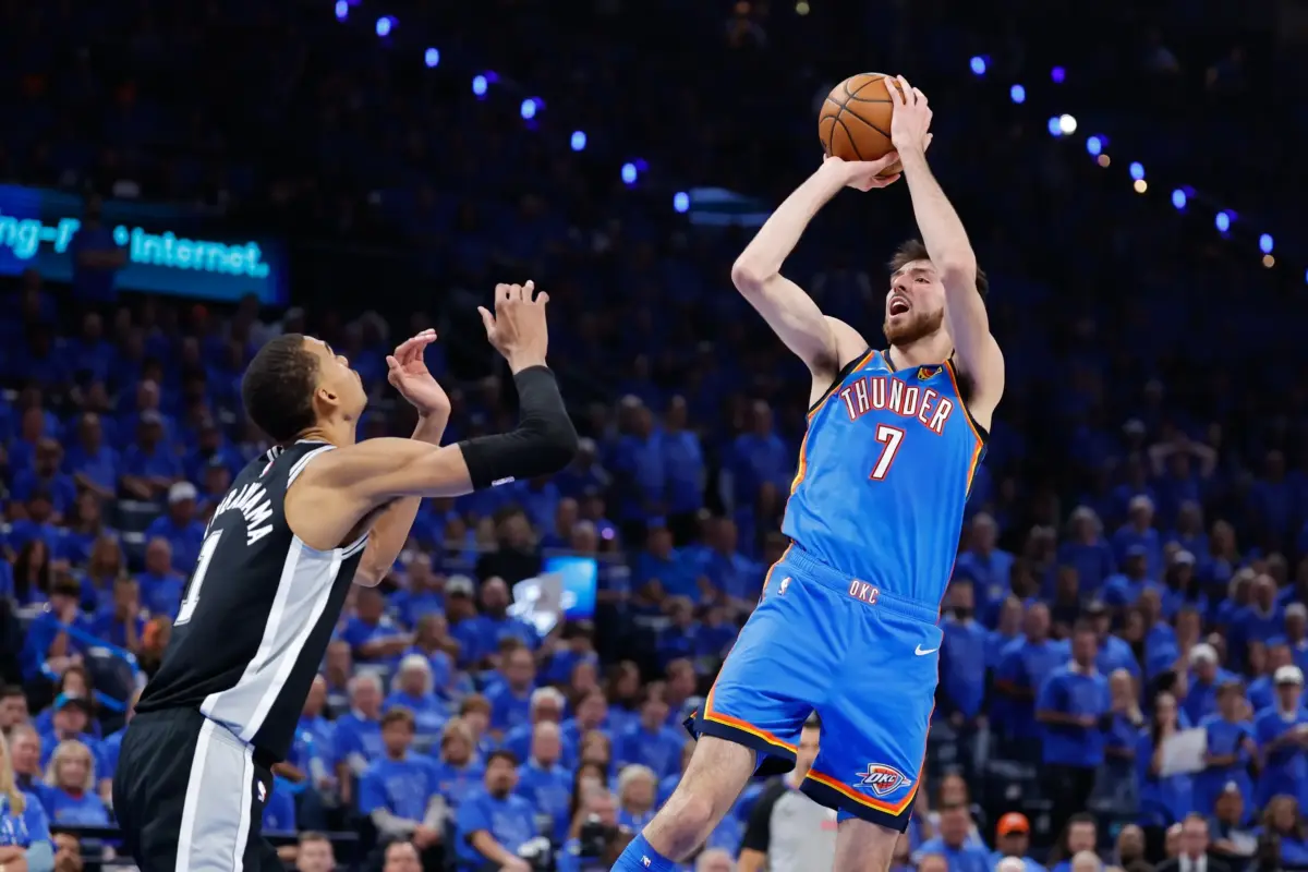 Oklahoma City Thunder center Chet Holmgren (7) shoots the ball while defended by San Antonio Spurs center Victor Wembanyama (1) in the third quarter during game one of the western conference finals for the 2026 NBA playoffs at Paycom Center.