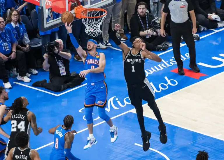 Oklahoma City Thunder guard Alex Caruso (9) shoots while defended by San Antonio Spurs center Victor Wembanyama (1) in double overtime during game one of the western conference finals for the 2026 NBA playoffs at Paycom Center.