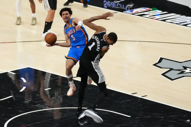 Oklahoma City Thunder guard Jared McCain attempts a layup against San Antonio Spurs center Victor Wembanyama