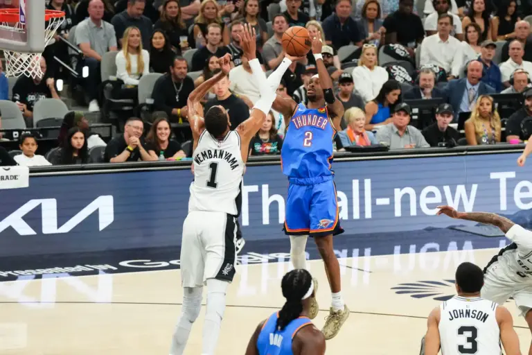 Oklahoma City Thunder guard Shai Gilgeous-Alexander (2) shoots while defended by San Antonio Spurs center Victor Wembanyama (1) in the first quarter during game four of the western conference finals for the 2026 NBA playoffs at Frost Bank Center.