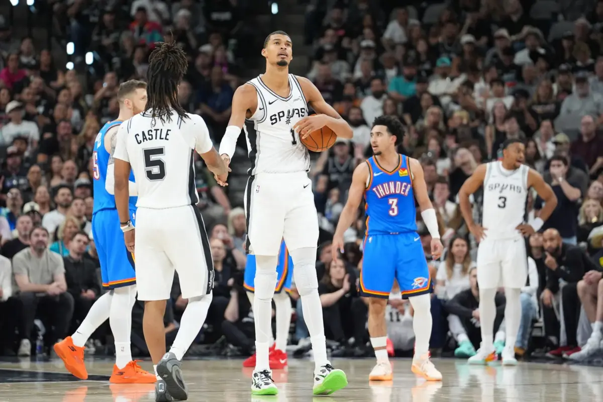 San Antonio Spurs center Victor Wembanyama (1) high fives guard Stephon Castle (5) in the fourth quarter during game four of the western conference finals for the 2026 NBA playoffs at Frost Bank Center.