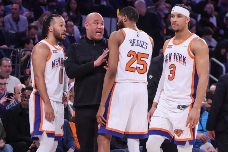 New York Knicks assistant coach Rick Brunson talks with New York Knicks guard Jalen Brunson (11), forward Mikal Bridges (25), and guard Josh Hart (3) during a timeout in the third quarter against the Boston Celtics at Madison Square Garden. The Knicks will face the San Antonio Spurs in the 2026 NBA Finals.
