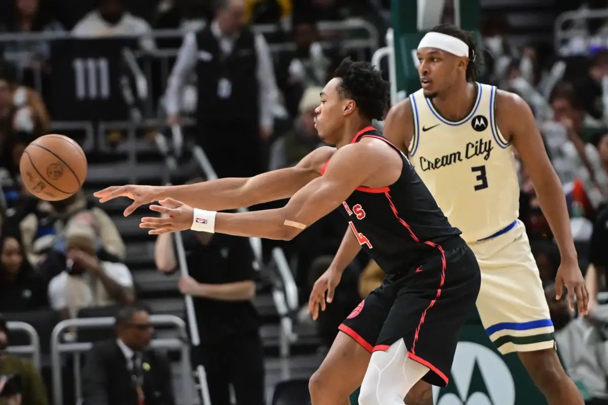 Dec 18, 2025; Milwaukee, Wisconsin, USA; Toronto Raptors guard Scottie Barnes (4) passes against Milwaukee Bucks center Myles Turner (3) in the third quarter at Fiserv Forum. Mandatory Credit: Benny Sieu-Imagn Images