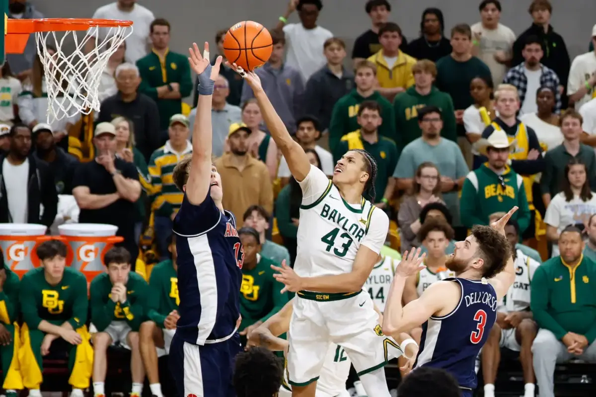 Feb 24, 2026; Waco, Texas, USA; Baylor Bears guard Cameron Carr (43) scores a layu[ ahead of Arizona Wildcats guard Anthony Dell'orso (3) during the second half at Paul and Alejandra Foster Pavilion. Mandatory Credit: Chris Jones-Imagn Images